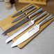 Набір кухонних ножів з обробною дошкою на дерев'яній підставці