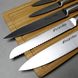 Набір кухонних ножів з обробною дошкою на дерев'яній підставці
